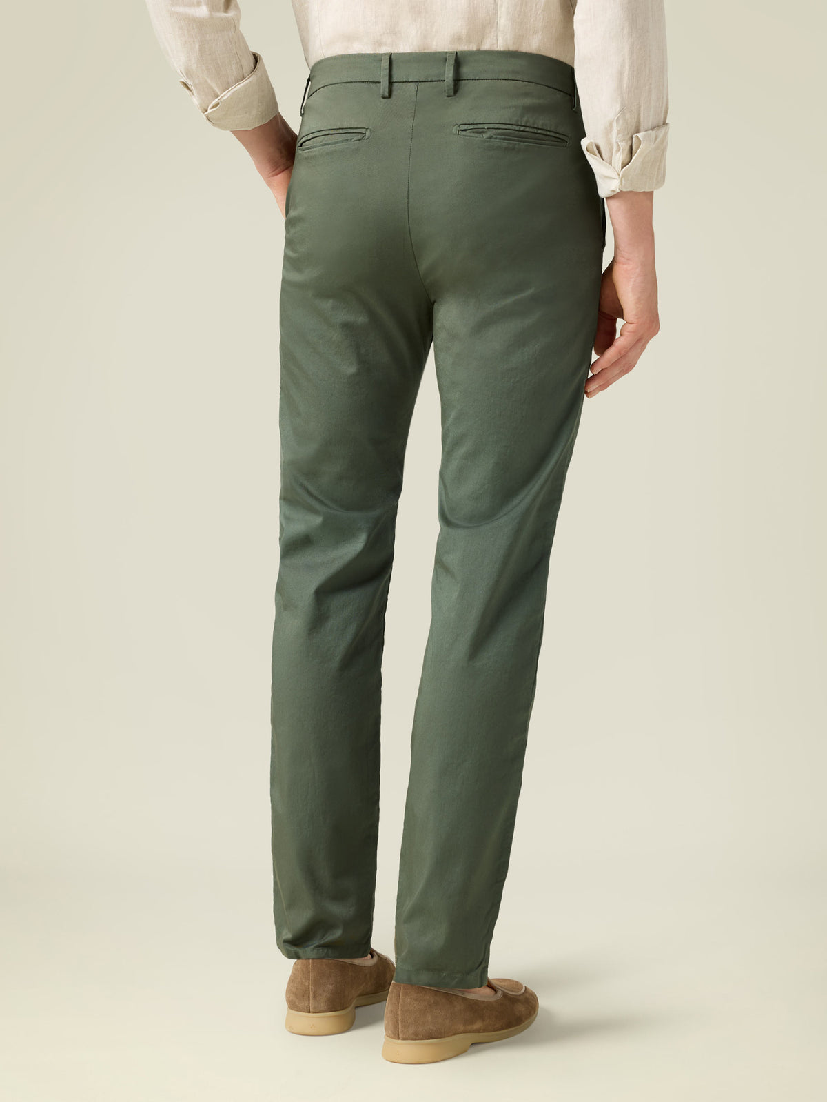 Rear view of a man wearing the Lightweight Cotton Chinos in olive green.