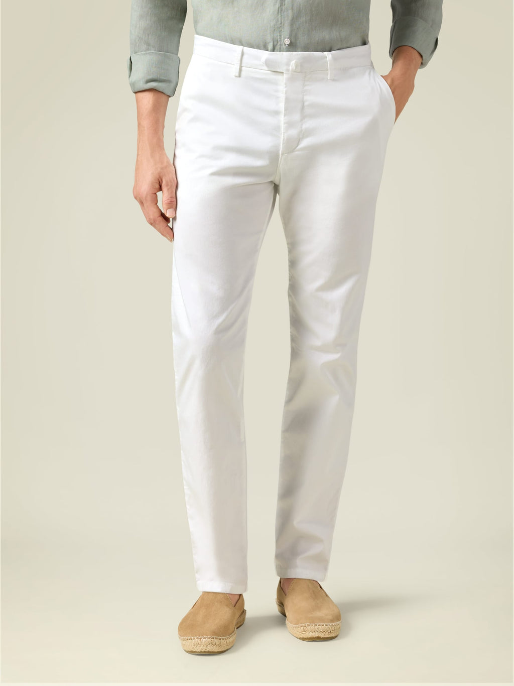 Front view of a model wearing Luca Faloni's white Lightweight Cotton Chinos, styled with a grey shirt and tan espadrilles.