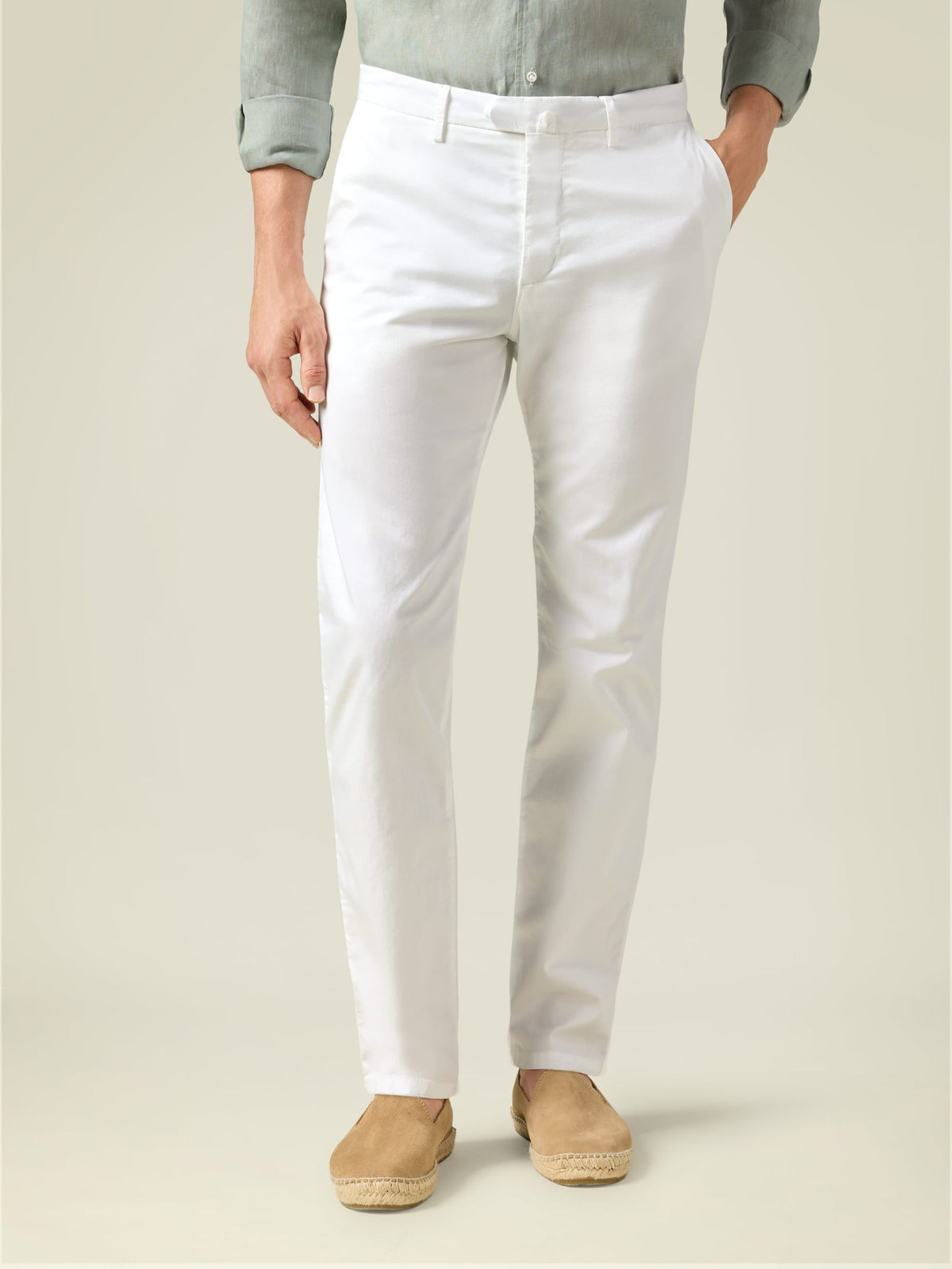 Front view of a model wearing Luca Faloni's white Lightweight Cotton Chinos, styled with a grey shirt and tan espadrilles.