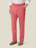 Model wears the Luca Faloni Lightweight Cotton Chinos in Strawberry, paired with a white shirt and brown loafers.