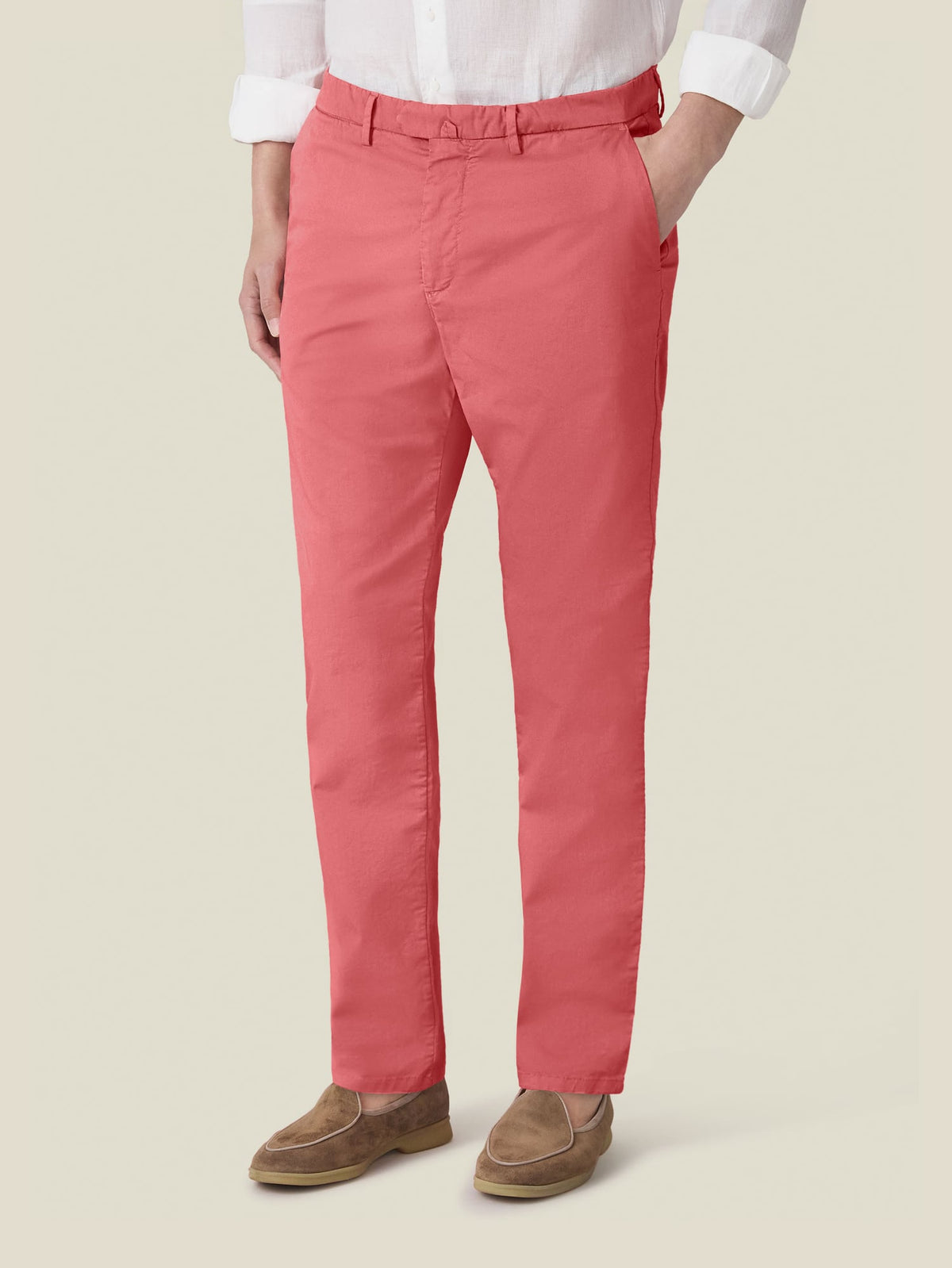 Model wears the Luca Faloni Lightweight Cotton Chinos in Strawberry, paired with a white shirt and brown loafers.