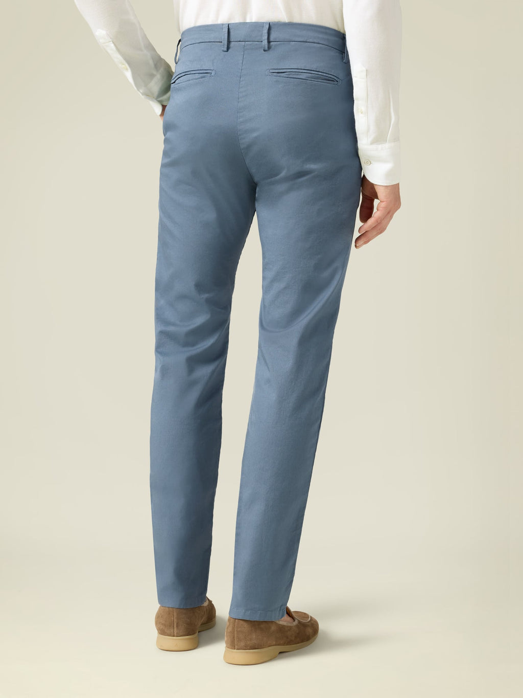 Back view of a man wearing Luca Faloni steel blue Lightweight Cotton Chinos with a white shirt and brown loafers.