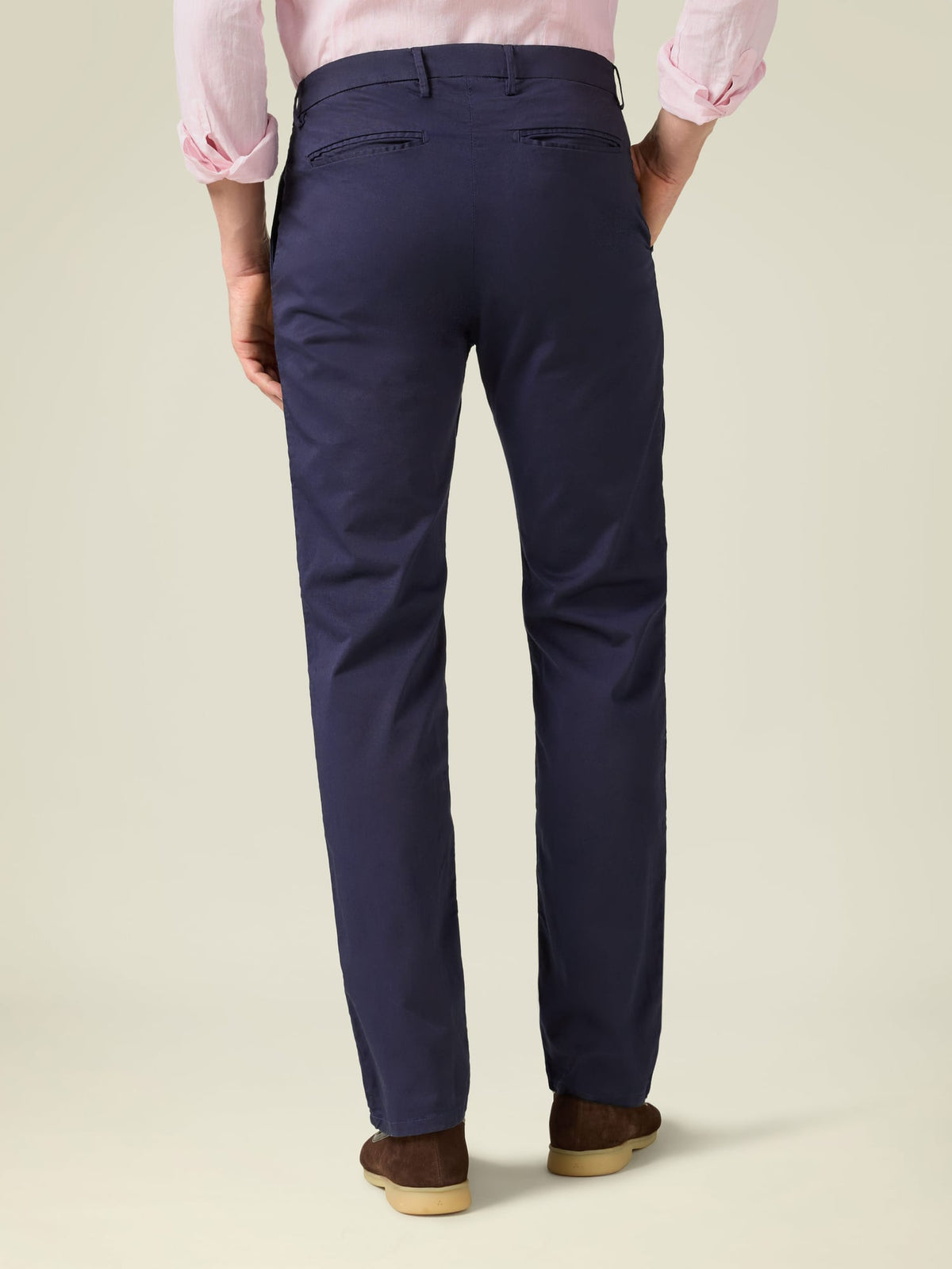Rear view of a model wearing the Navy Blue Lightweight Cotton Chinos, highlighting the tapered fit and back pocket details.