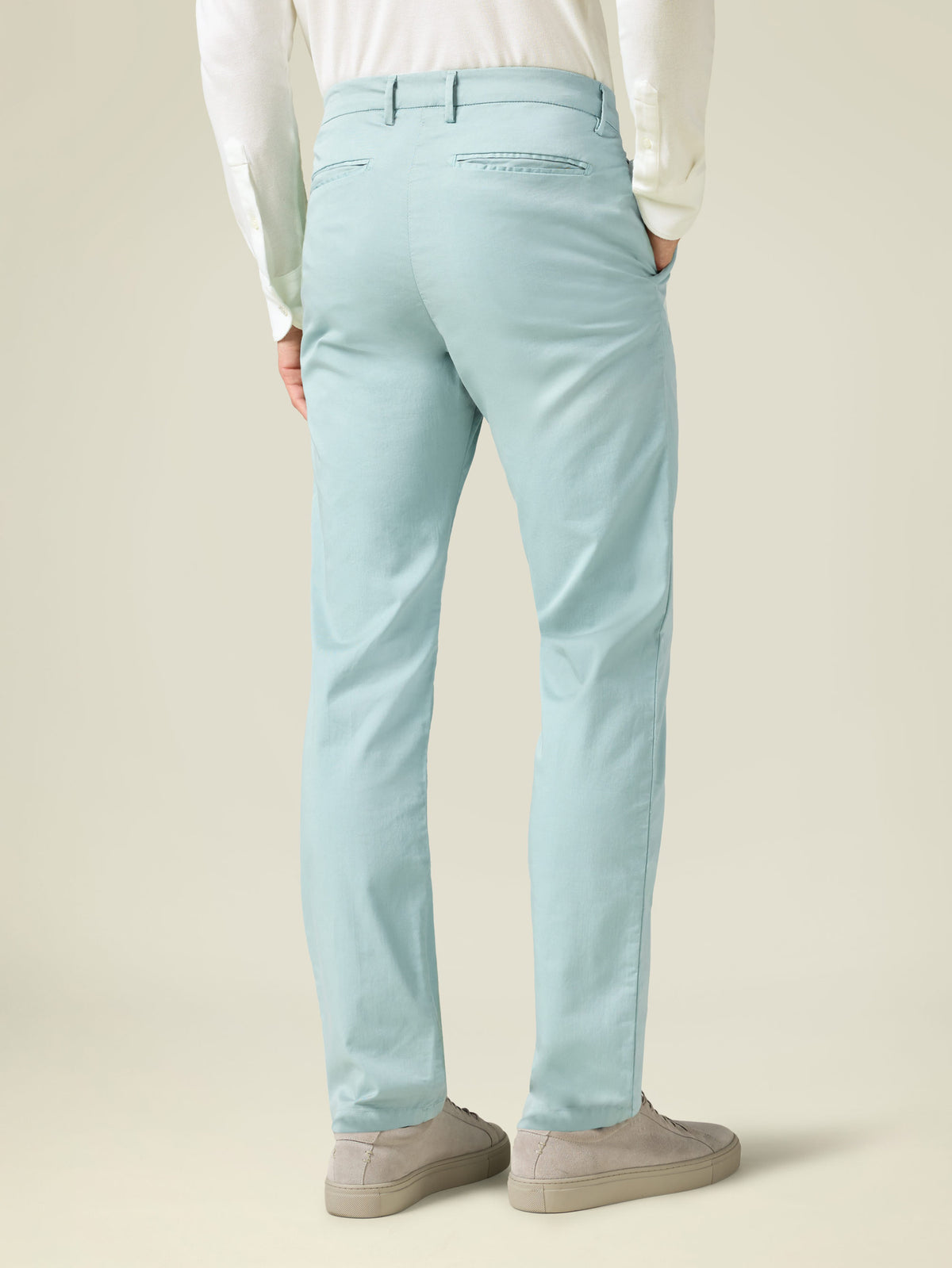 Back view of a model wearing Turquoise Lightweight Cotton Chinos, showcasing the tapered fit and rear pocket details.