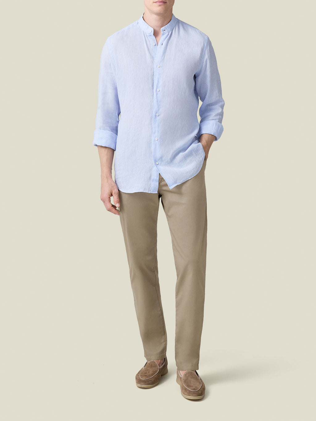 Front view of a model wearing Luca Faloni's Hazelnut Brown Lightweight Cotton Chinos with a light blue band collar shirt.