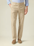Front view of a model wearing cream Lightweight Cotton Chinos, paired with a light blue shirt and brown suede loafers.