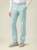 Side view of a man wearing Luca Faloni's Turquoise Lightweight Cotton Chinos with a white shirt and grey sneakers.