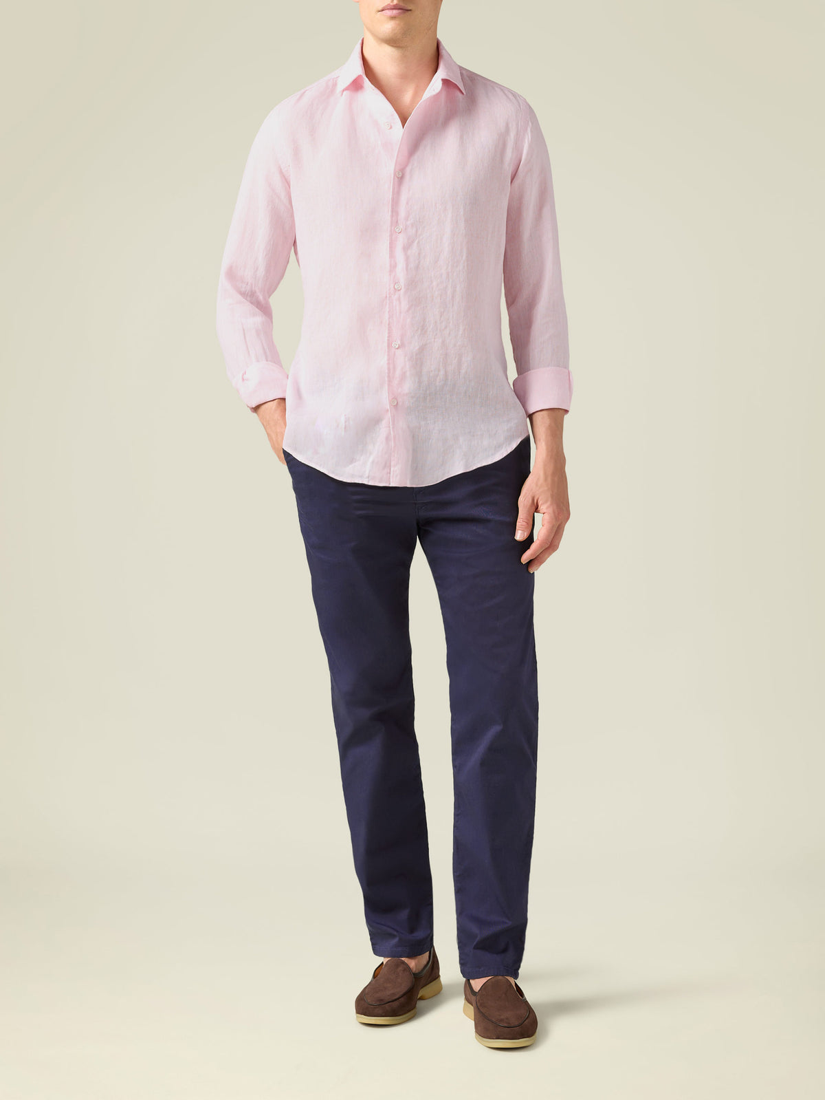 Full-length, front view of a model wearing the Navy Blue Lightweight Cotton Chinos with a pink shirt and brown loafers.