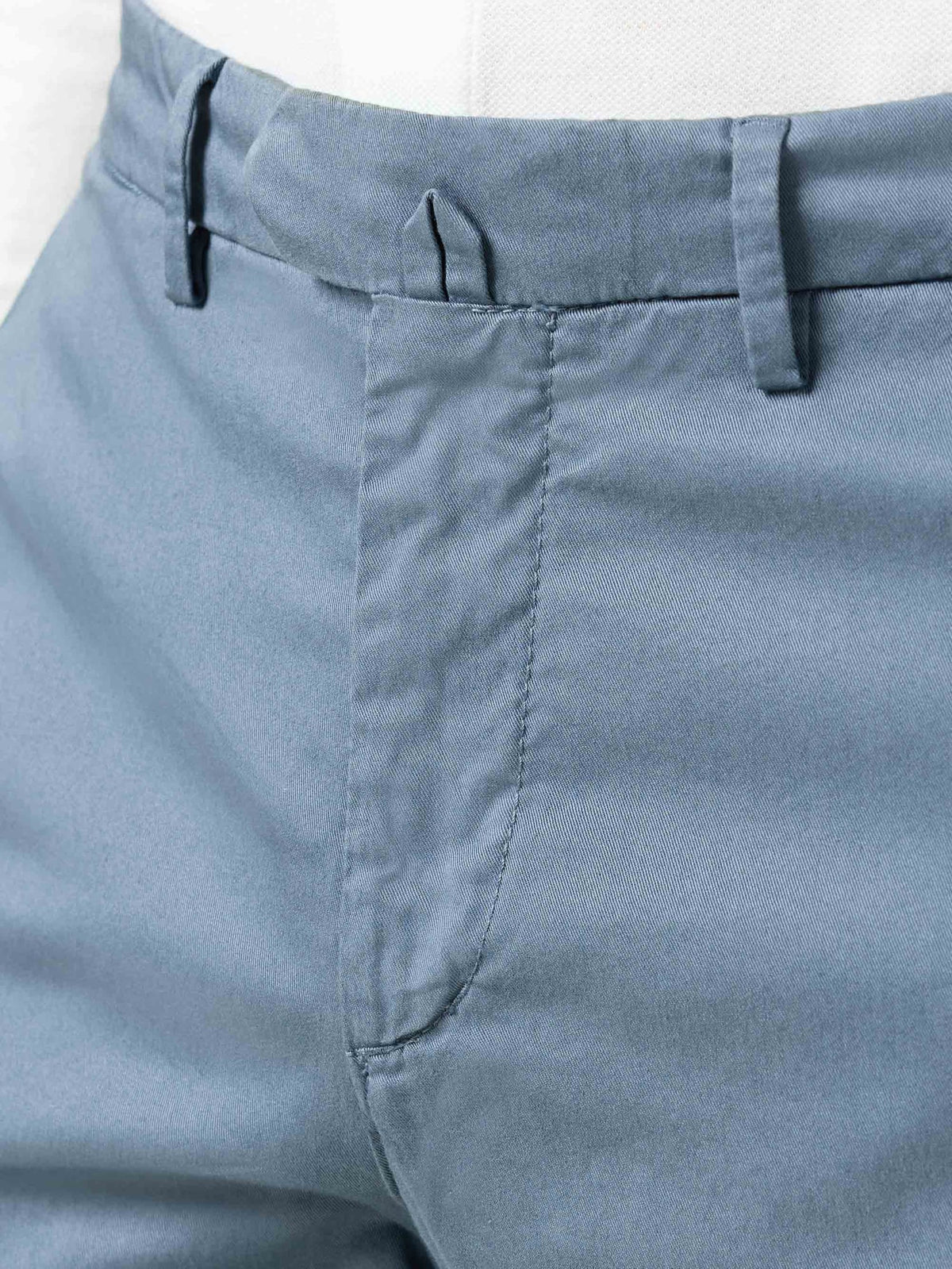 Detail shot of the waistband, fly, and central belt fastener on the Steel Blue Lightweight Cotton Chinos.