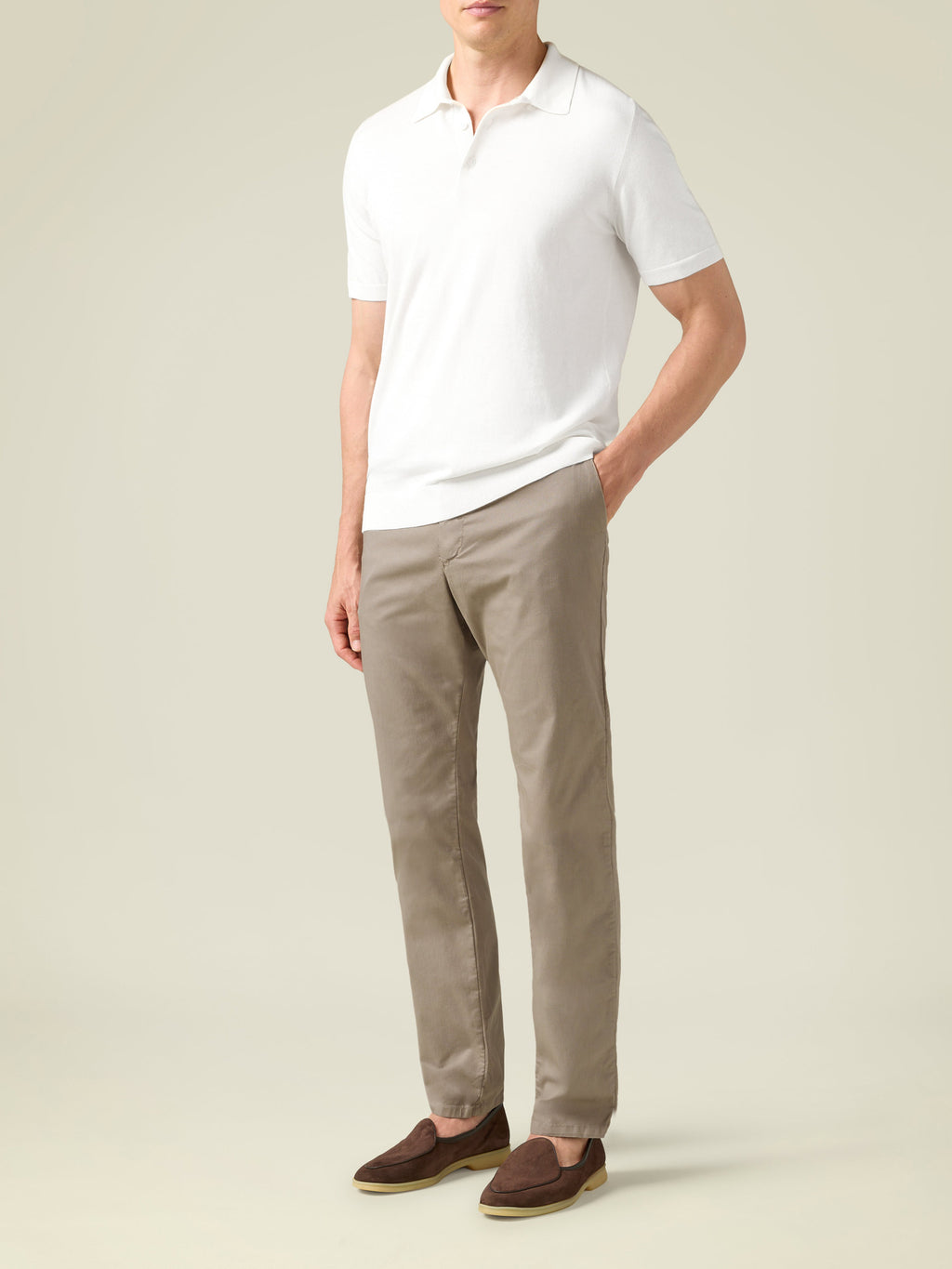 A model wears the Cortina Cotton Chinos in Hazelnut Brown, styled with a white polo shirt and brown loafers.