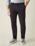 A model showcases the tapered fit of the Black Cortina Cotton Chinos, styled with a grey shirt and matching sneakers.