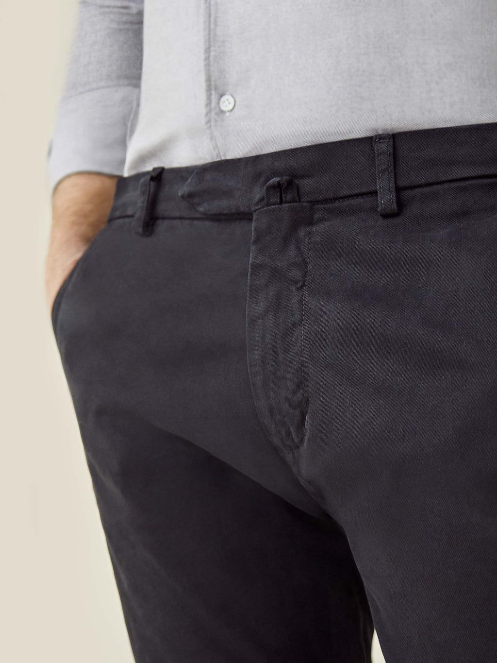 A close-up of a model wearing the Luca Faloni Black Cortina Cotton Chinos, highlighting the waistband and fly details.