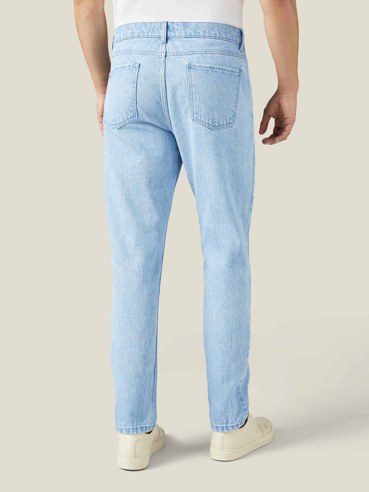 Back view of Luca Faloni's Light Blue Tapered Jeans, focusing on the fit and the clean, rivetless back pockets.