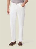 Front view of a model wearing Luca Faloni's white denim jeans, styled with brown loafers and a grey t-shirt.