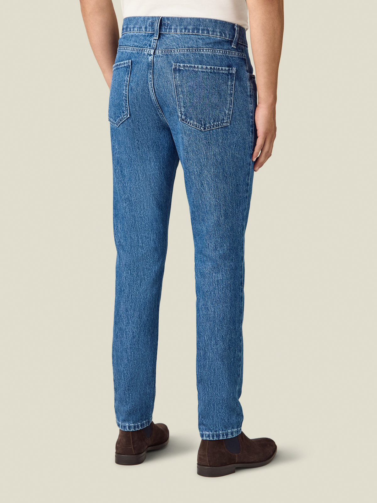 Back view of a model wearing the Luca Faloni Jeans in classic blue.