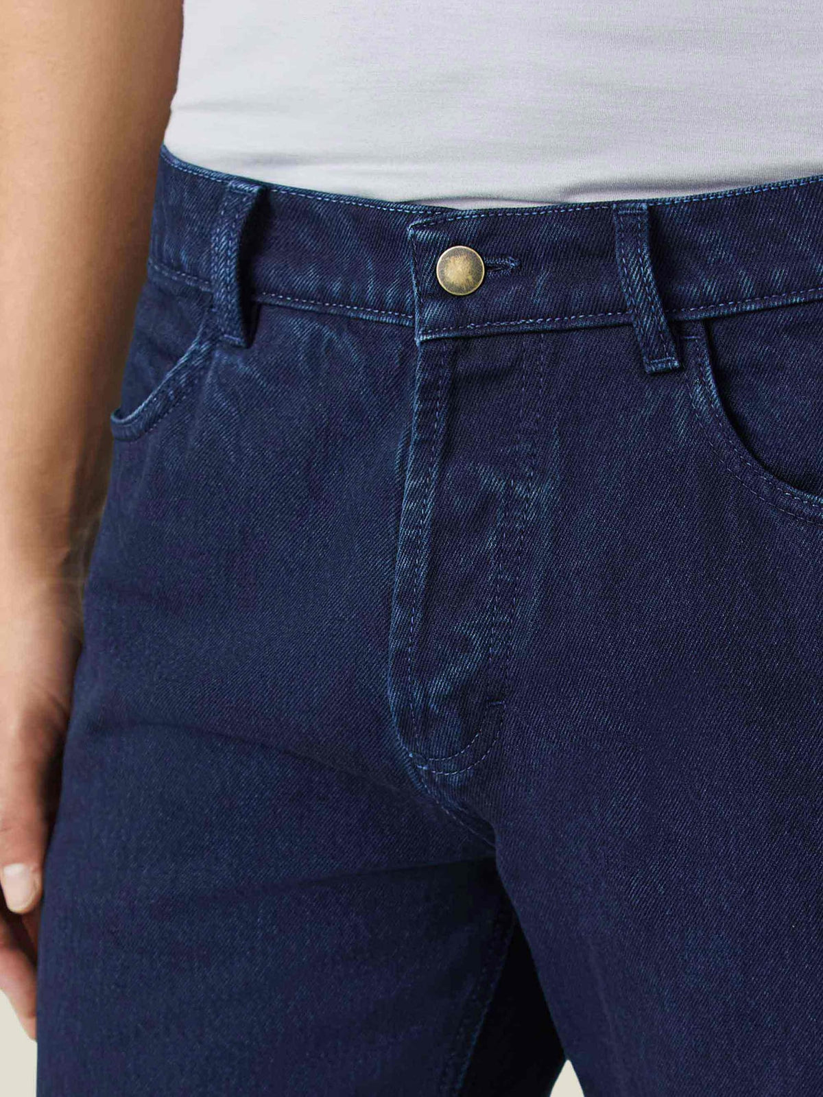 A close-up of Luca Faloni's Dark Blue Jeans, detailing the button-fly closure, front pocket, and rivetless design.