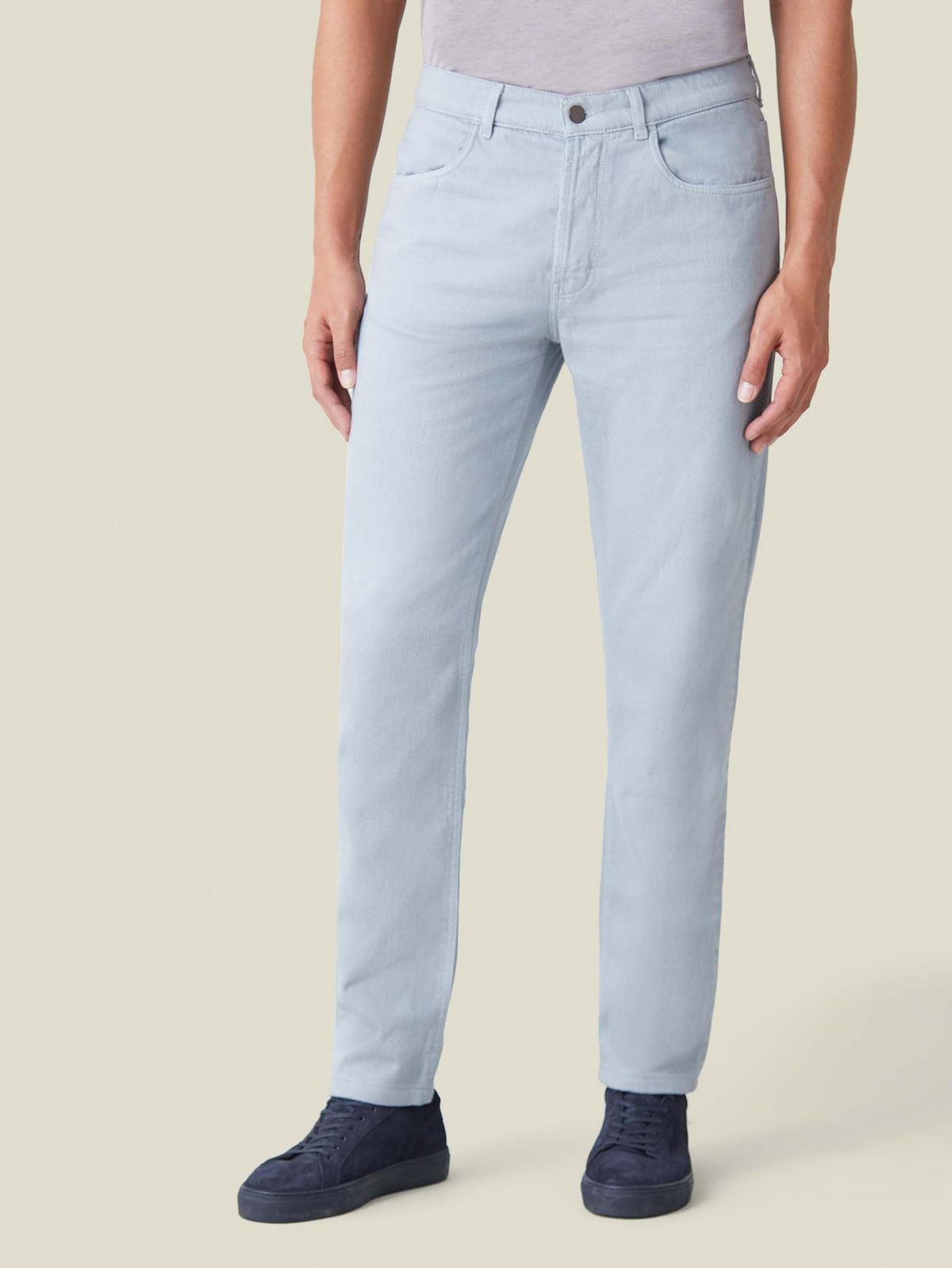 Front view of a model in Luca Faloni's Light Grey Denim Jeans, showcasing the tapered fit and mid-rise cut.