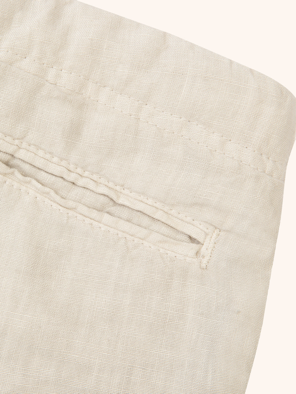 Close-up of the back pocket detail on the Sand Lipari Junior Linen Trousers, showcasing the pure linen fabric and stitching.