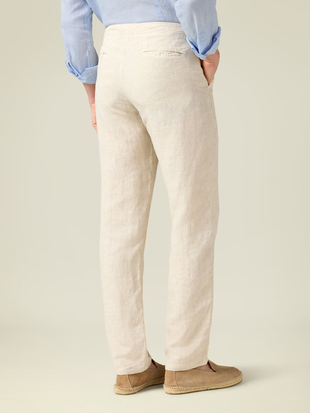 Back view of a model wearing the Luca Faloni Lipari Linen Trousers in sand.