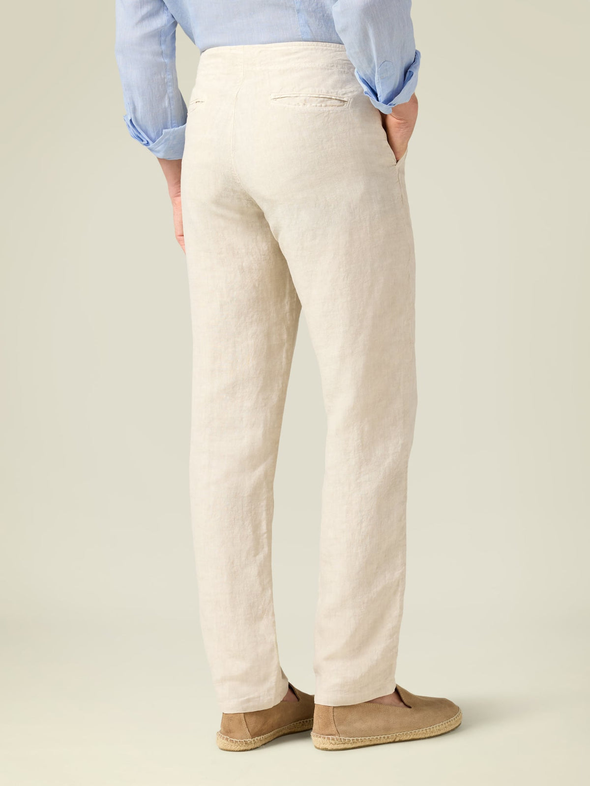 Back view of a model wearing the Luca Faloni Lipari Linen Trousers in sand.