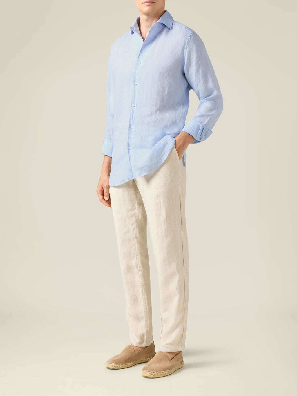Side view of a model wearing the Luca Faloni Lipari Linen Trousers in sand.