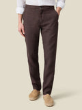 Front view of a model wearing Luca Faloni's Lipari Linen Trousers in chocolate brown.