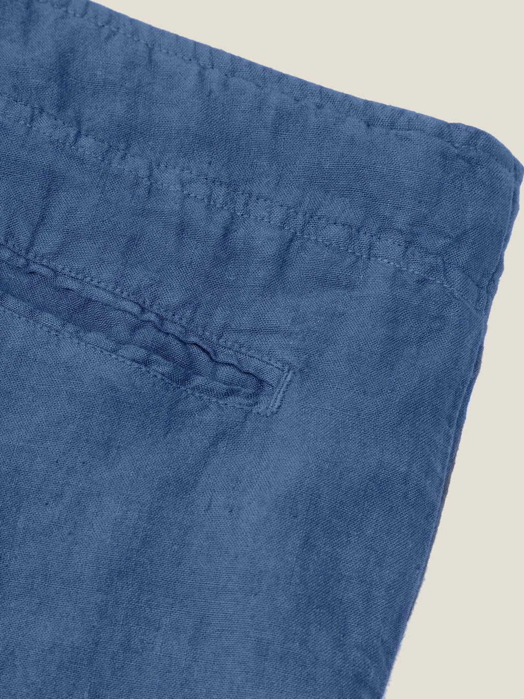 Close-up of the back pocket detail and pure linen texture of the Lipari Linen Trousers in Capri Blue.