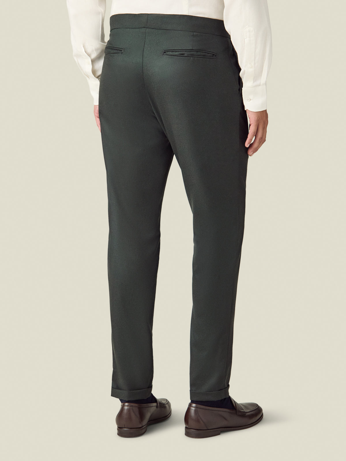 Back view of a model wearing the Luca Faloni Wool Pleated Trousers in khaki green.