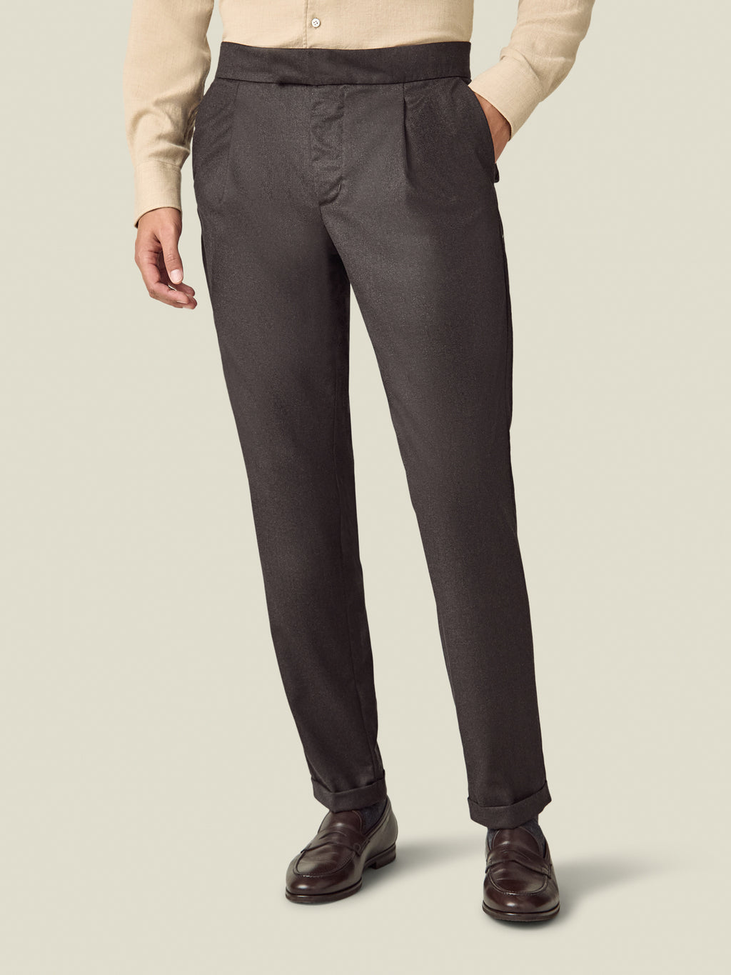 Front view of a model wearing the Luca Faloni Wool Pleated Trousers in chocolate brown.