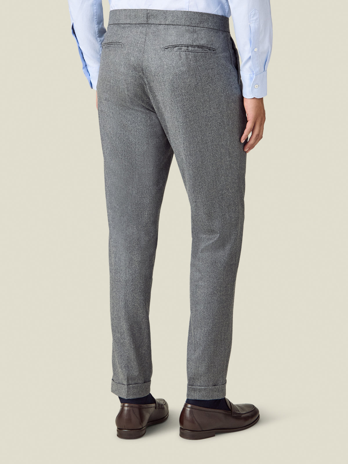 Back view of a man wearing the Luca Faloni Wool Pleated Trousers in light grey.