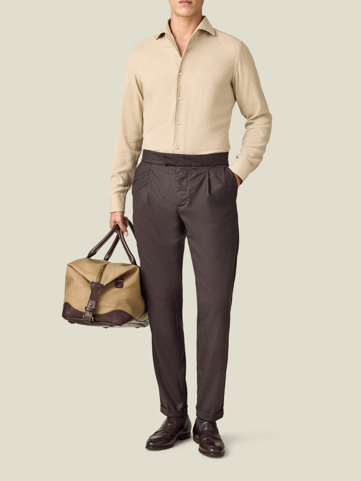 Front view of a model wearing Luca Faloni's Wool Pleated Trousers in chocolate brown against a plain background.
