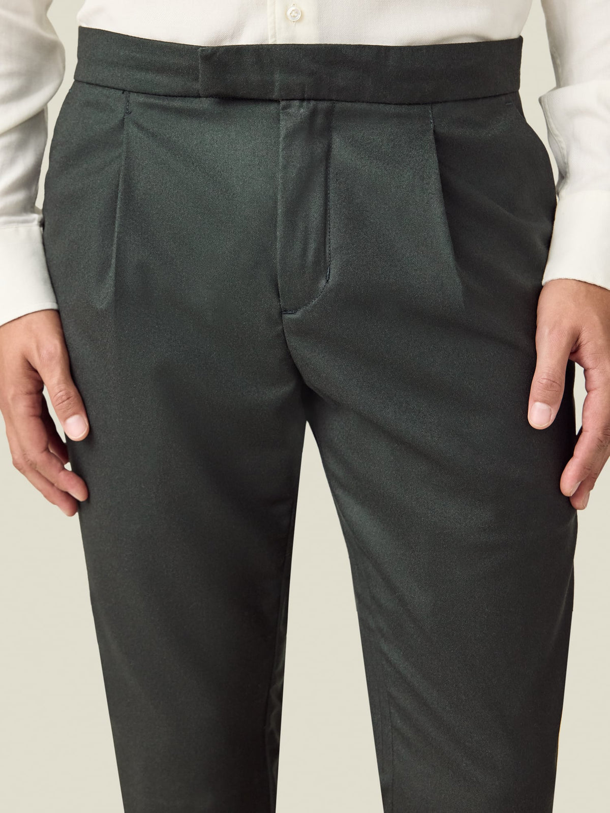 Close-up of the front of the Luca Faloni Wool Pleated Trousers in khaki green, showing the waistband and pleat detail.