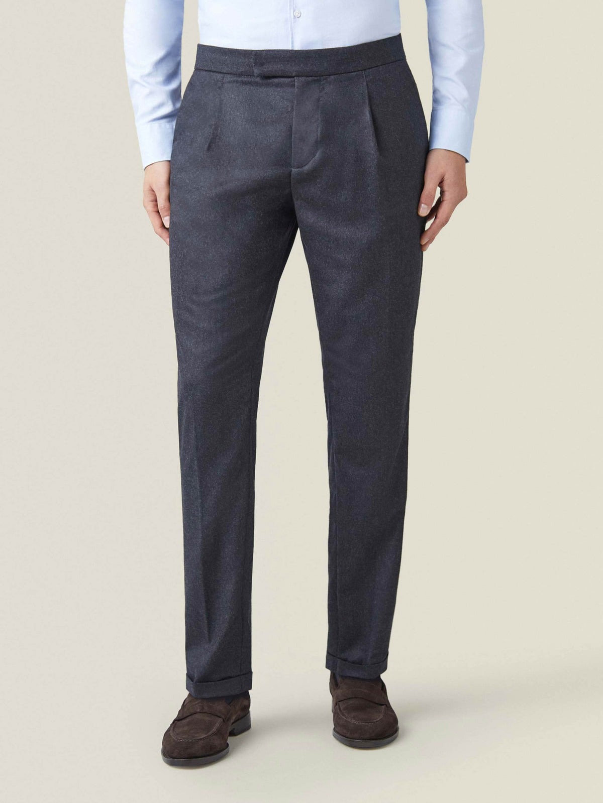 Front view of a model wearing Luca Faloni's Charcoal Grey Wool Pleated Trousers.