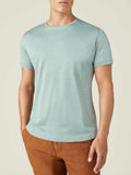 Front view of a model wearing the Luca Faloni Silk-Cotton T-Shirt in Marine Green.
