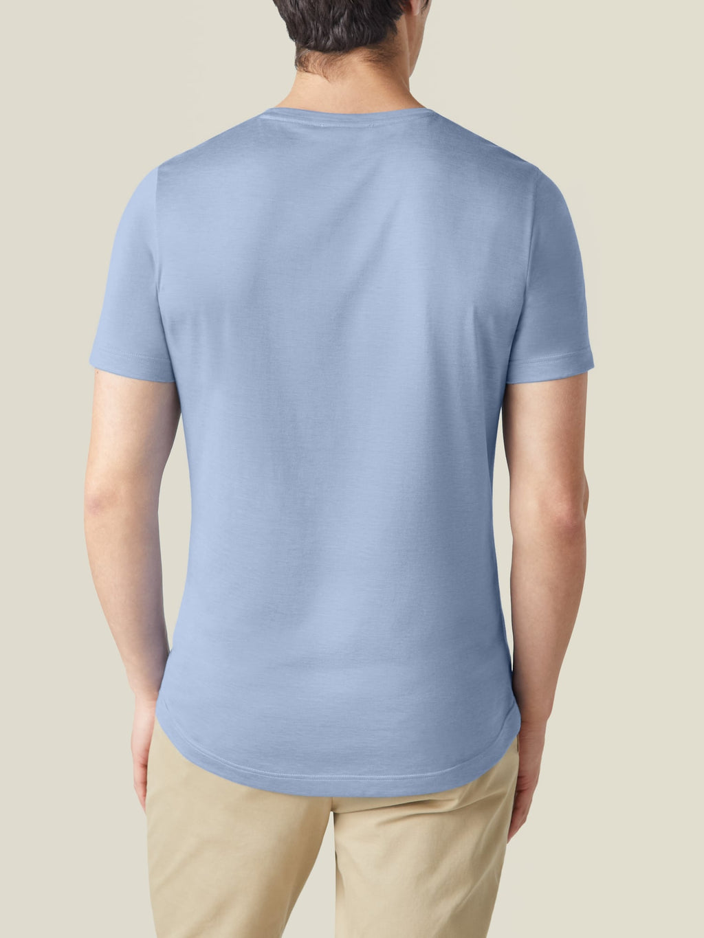 Back view of a model wearing the Luca Faloni Silk-Cotton T-Shirt in light blue.