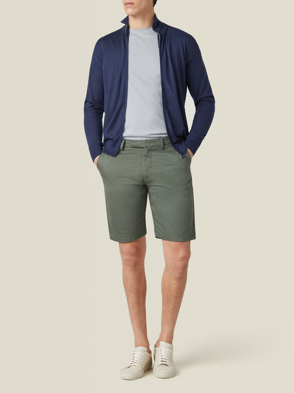 Model wears the light grey Silk-Cotton T-Shirt, styled with a navy zip cardigan, olive shorts, and white trainers.