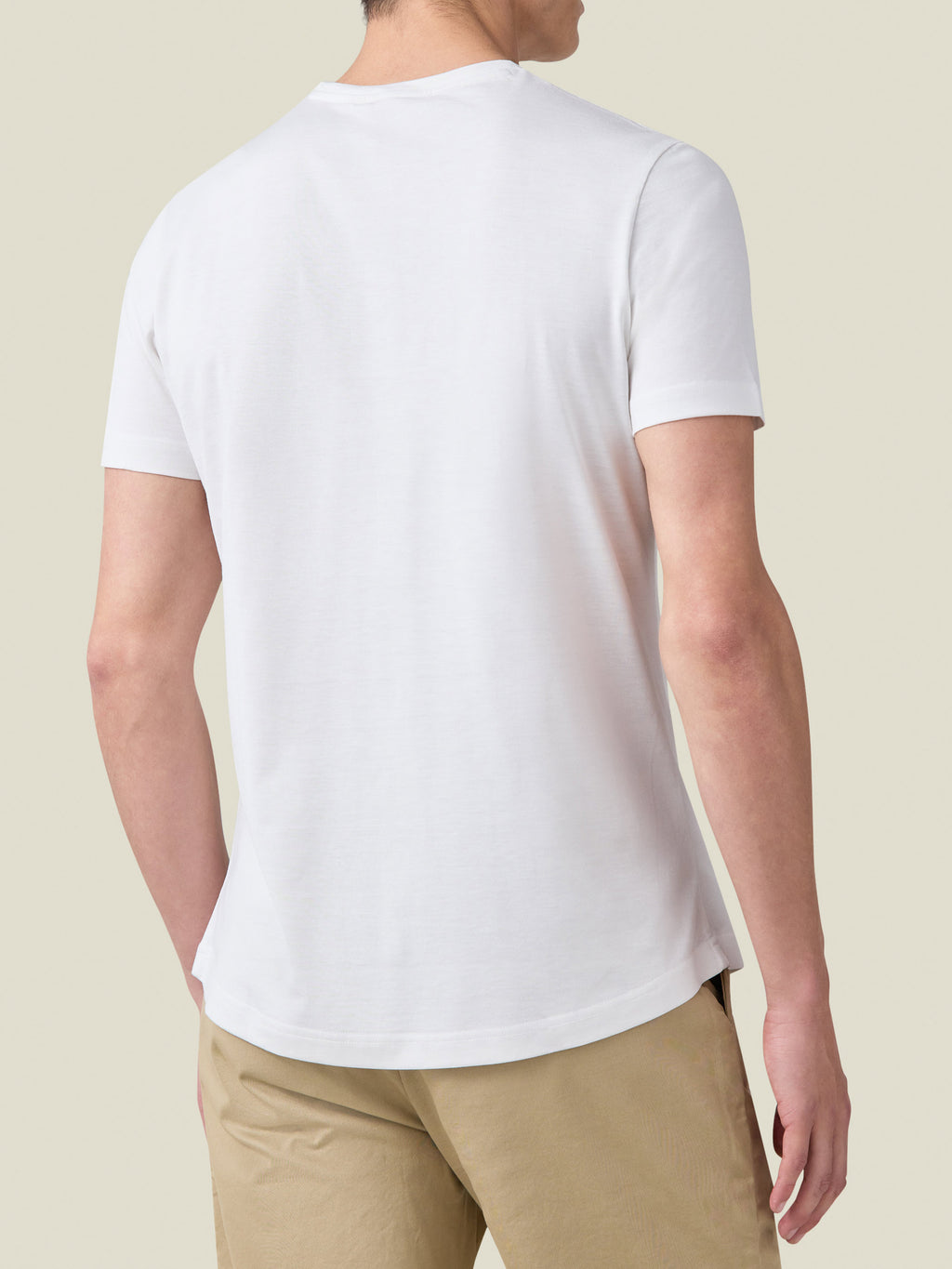 Back view of a model wearing the white Silk-Cotton T-Shirt, showcasing the classic fit and rounded hemline.
