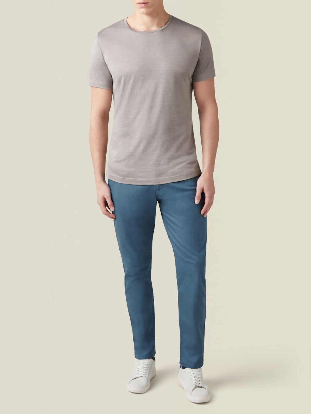 Front view of a model wearing the Nocciola Brown Silk-Cotton T-Shirt, paired with slim blue trousers and white sneakers.