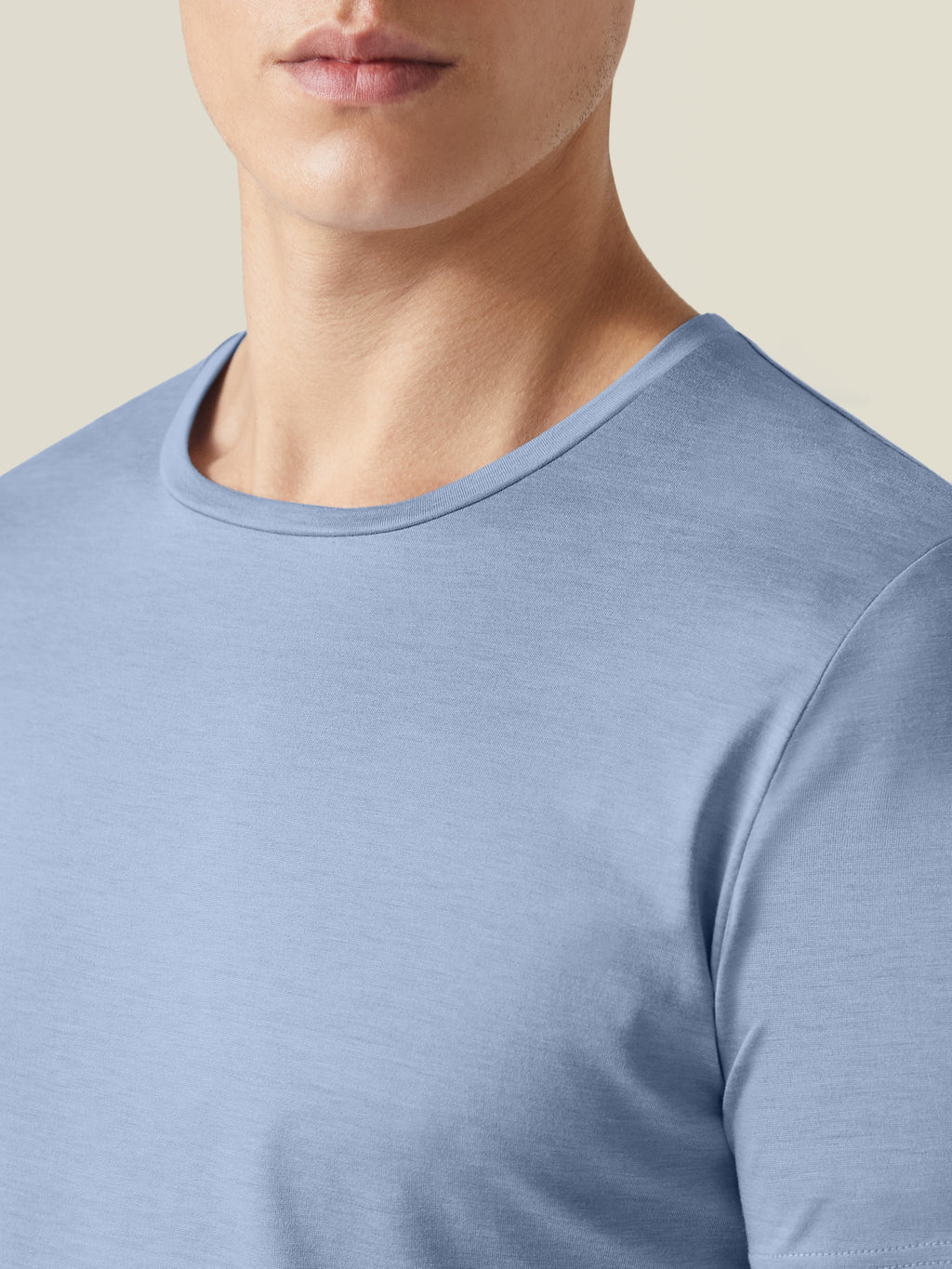 Close-up detail of the crew neckline of the Luca Faloni Silk-Cotton T-Shirt in light blue.