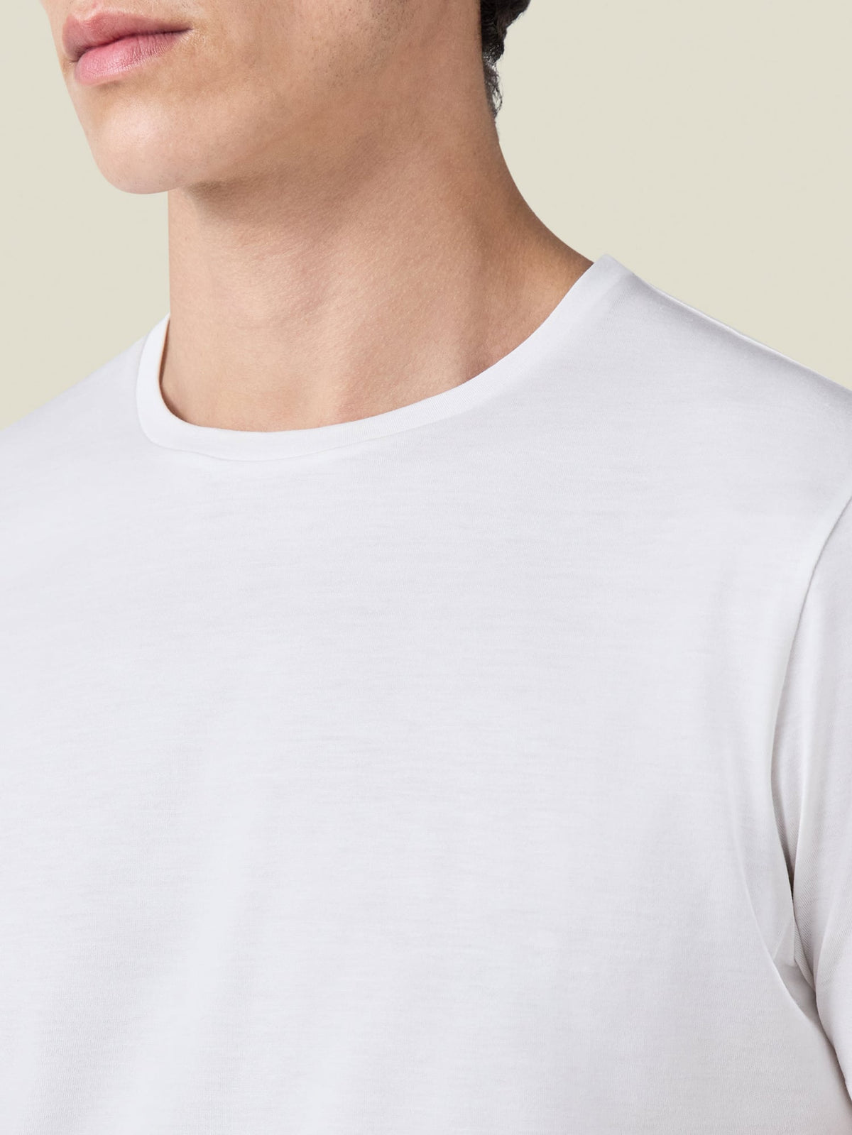 Detail shot of the white Silk-Cotton T-Shirt's crew neckline and premium fabric.