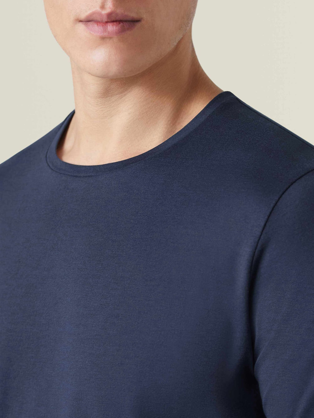 A close-up of a model wearing the Silk-Cotton T-Shirt in Midnight Blue, showing the detailed crew neckline and smooth fabric.