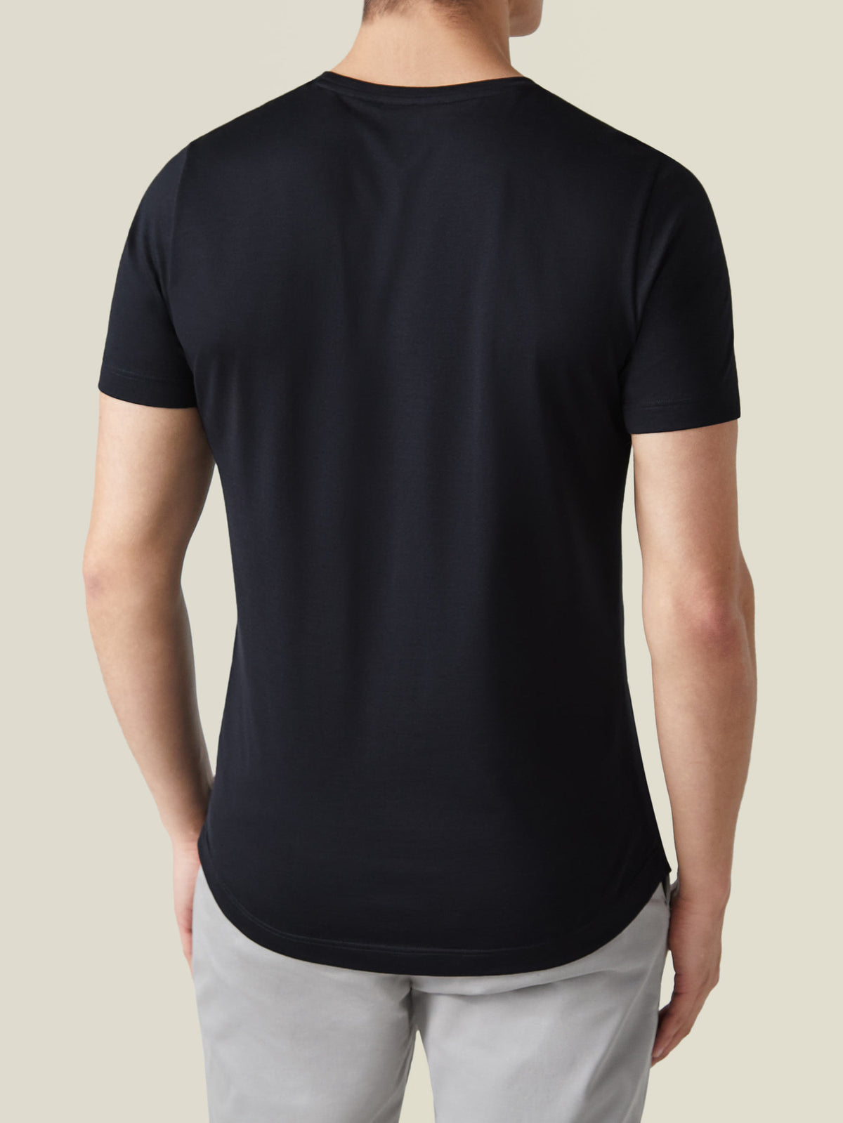 Back view of a model wearing the Luca Faloni Black Silk-Cotton T-Shirt, highlighting the classic fit and curved hem.