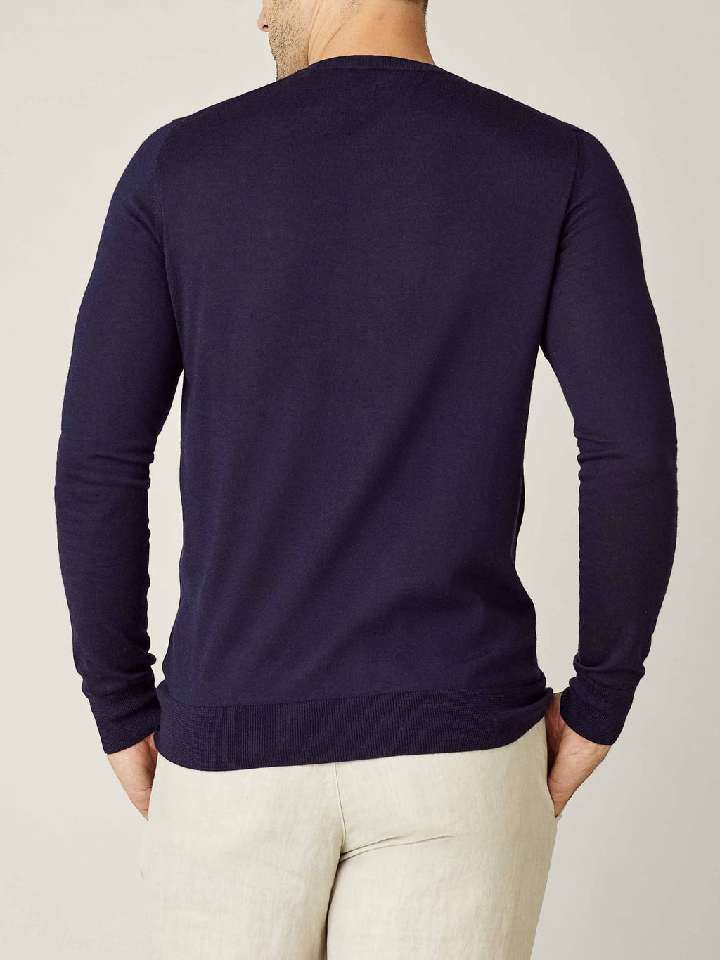 Back view of a model wearing the Luca Faloni Silk-Cashmere V-Neck in navy blue, highlighting its tailored fit.