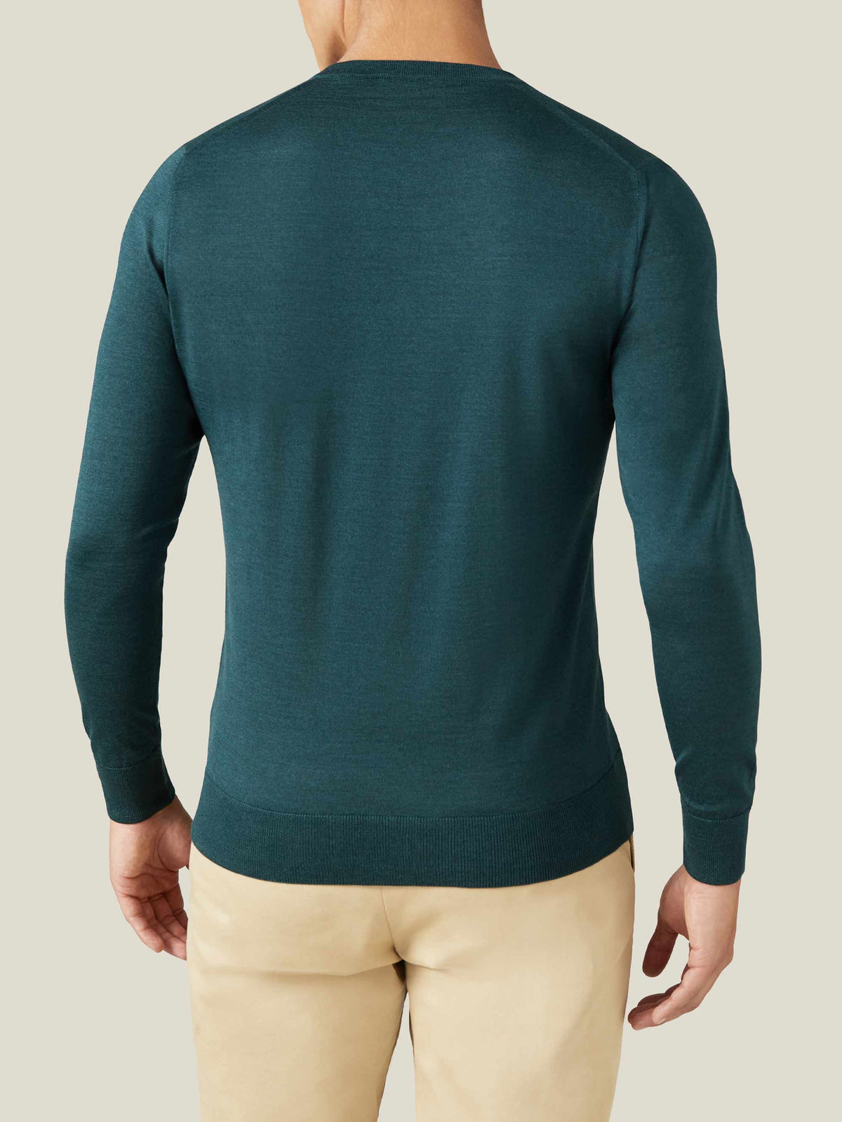 Back view of a model wearing the Luca Faloni Silk-Cashmere V-Neck in Forest Green, showing its tailored fit.