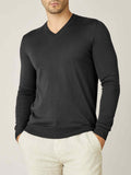 Front view of a model wearing the Luca Faloni Silk-Cashmere V-Neck jumper in Charcoal Grey, paired with light trousers.