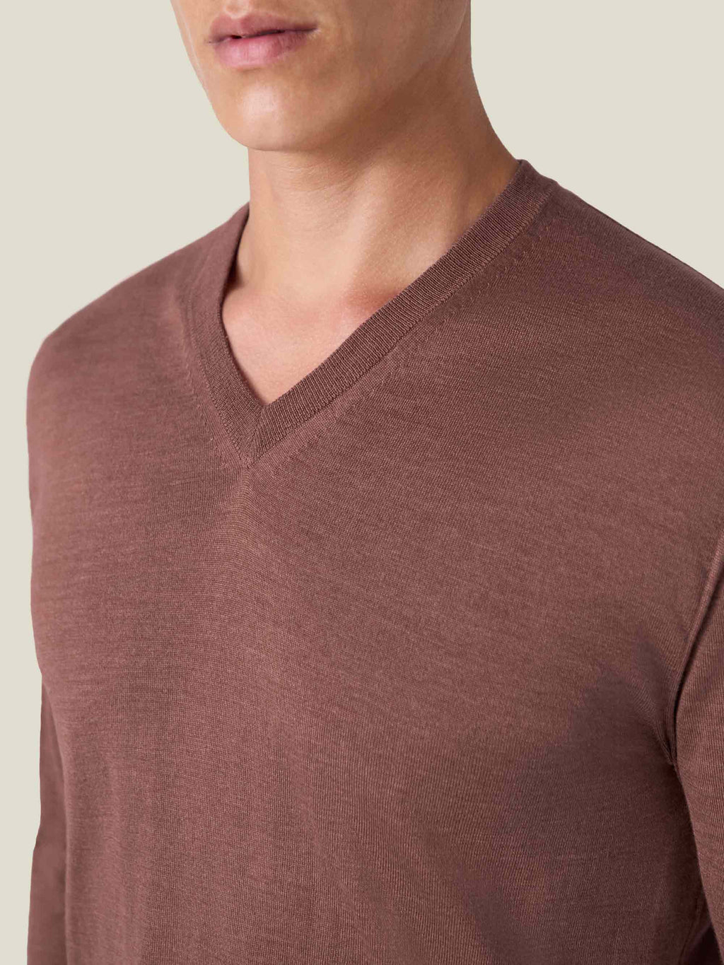 Close-up of the Luca Faloni Silk-Cashmere V-neck in Desert Rose, showing the detail of the fine knit and ribbed neckline.