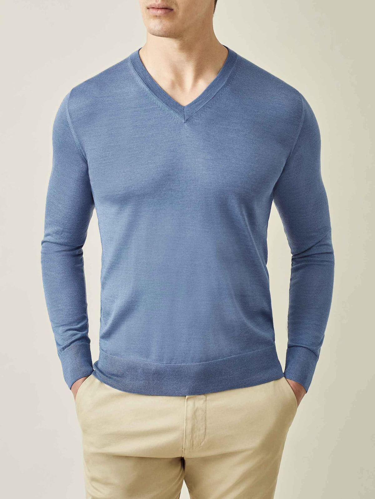 Front view of a model wearing the Luca Faloni Silk-Cashmere V-Neck in Azure Blue, paired with beige chinos.