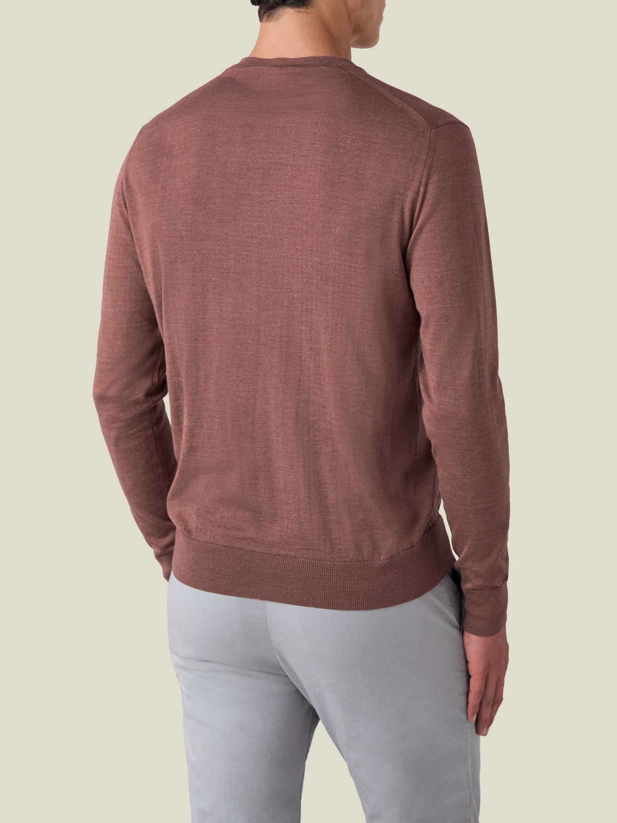 Back view of a man wearing the Luca Faloni Silk-Cashmere V-Neck sweater in Desert Rose.