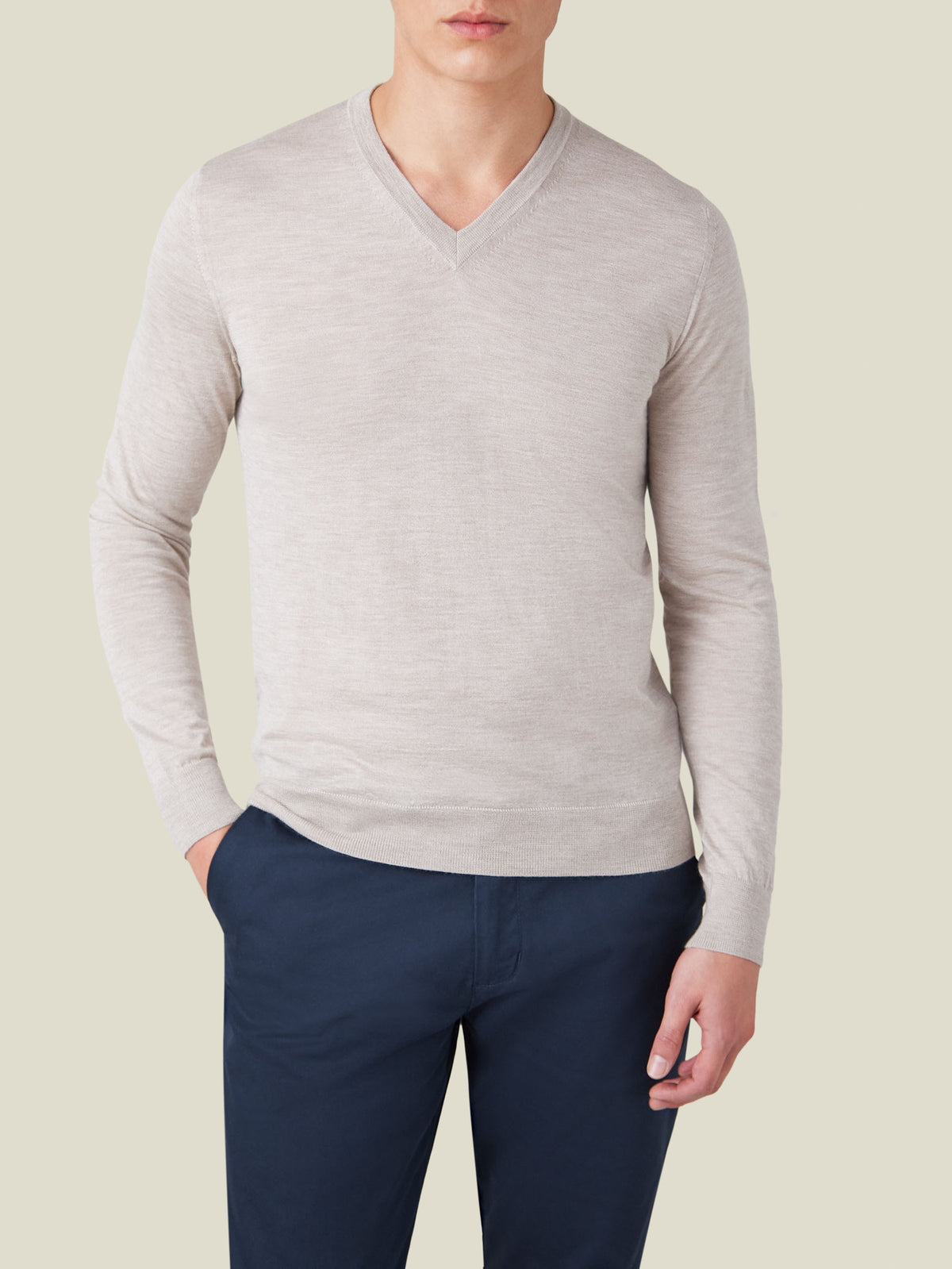 Model wearing the Oatmeal Silk-Cashmere V-Neck sweater with dark trousers.
