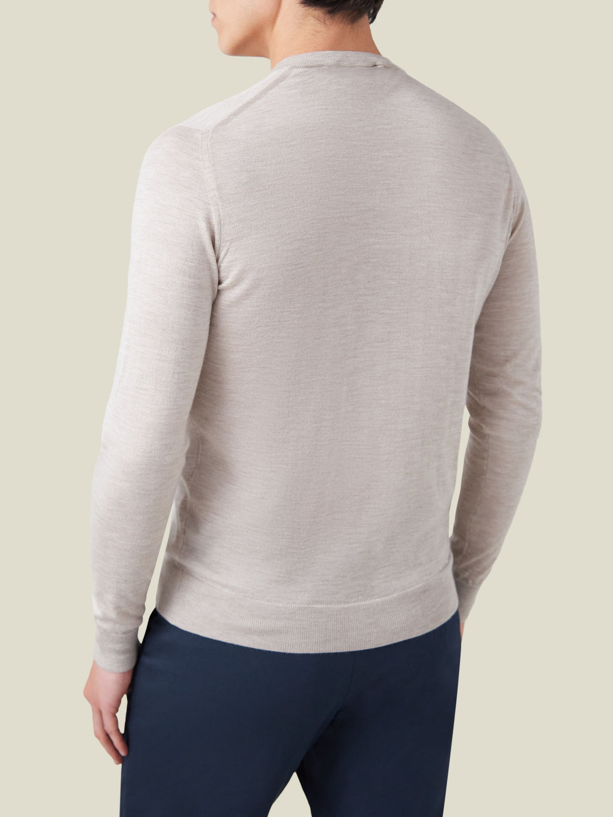 Back view of a man wearing the Luca Faloni Silk-Cashmere V-neck jumper in oatmeal.